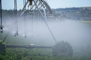 Irrigation equipment on farm field on sunny day photo