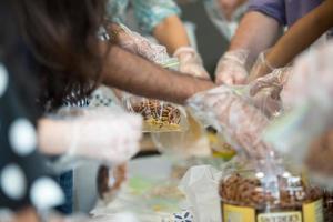 students of coworkers making food for charity or homeless people photo