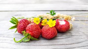 Strawberry close-up with dry yellow sprigs of sedge photo