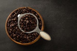 Coffee beans in wooden bowl on grunge background photo