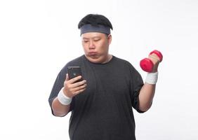 Young Asian funny fat sport man exercise with dumbbell photo