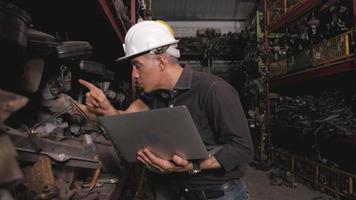 Two Men Checking Engine Parts in A Warehouse video