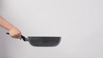 Man hand on white background cleaning the non stick pan photo