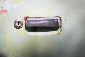 old rusty car door with keyhold