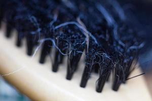 Close-up of a brush with lost hair on it, with shallow depth of field. photo