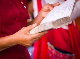 Hand holding book to read photo