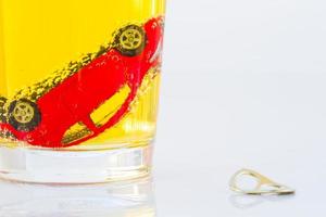 horizontal photo of red toy car in a glass of beer