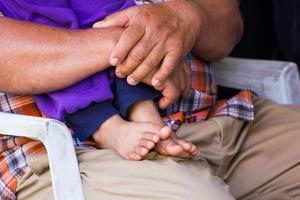 close-up child standing on lap of father photo