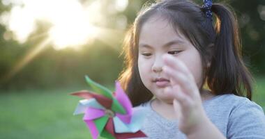 ragazza divertente con girandola colorata in giardino video