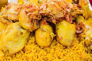 close up Chicken Biryani with green chutney in thai market photo