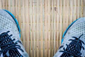 closeup running shoes on traditional mat, copyspace photo