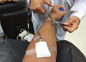 horizontal photo of closeup nurse taking blood sample