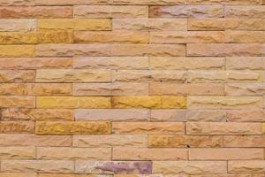 Wall made from yellow sandstone bricks, abstract background