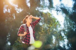 Young asian woman wiped sweat during hiking. photo