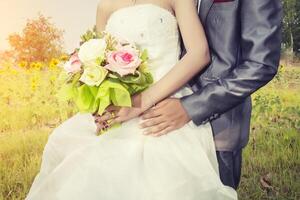 Beautiful bouquet of different colors in the hands of the bride. photo