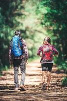Rear of the couple hiking. Couple adventure travel. photo