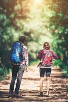 Rear of the couple hiking. Couple adventure travel. photo
