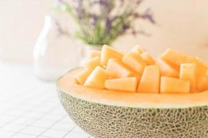 Fresh cantaloupe melon for dessert on table photo