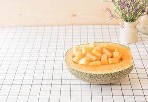 Fresh cantaloupe melon for dessert on table photo