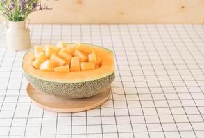 Fresh cantaloupe melon for dessert on table photo