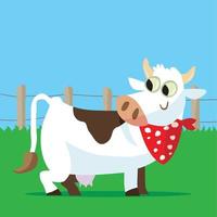 Cow with a spotted neckerchief in front of a fence in a field