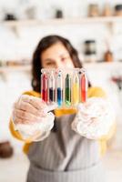 woman holding tubes with colorful liquids photo