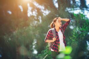 Young asian woman wiped sweat during hiking. photo