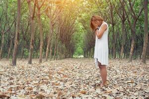 sad unhappy woman in the green forest, stress, depression photo