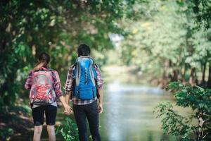 Hiking couple in forest together. Adventure travel vacation.