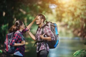 Hiking couple in forest together. Adventure travel vacation. photo