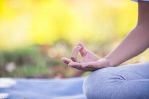 Young asian woman doing yoga in the park photo