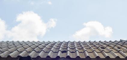 roof of house in cloudy sky as background photo