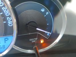 Fuel gauge showing empty tank with yellow glowing and lit meter photo