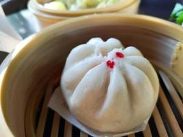 close-up steam chinese pork bun in wooden container sold in Thailand photo