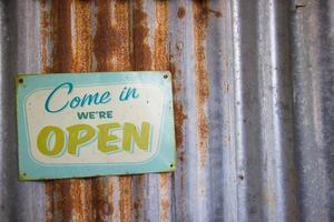 Vintage open sign on rustic galvanized iron photo