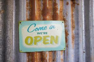 Vintage open sign on rustic galvanized iron photo