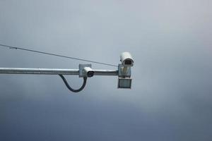 Close-up camera speed control isolated against cloudy sky background photo