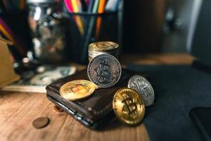 Bitcoin coins on a wooden desk photo