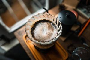 drip coffee in house,Pouring a hot water over a drip coffee photo