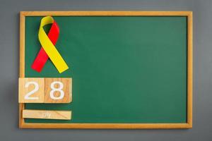 World hepatitis day awareness with red yellow ribbon photo