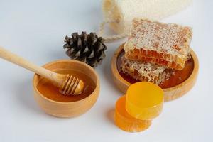 Natural skin care soap and serum with honey and honeycomb laid photo
