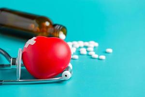 Doctor's stethoscope and red heart and pill seeds photo