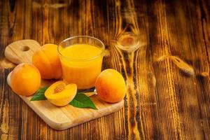 Peach juice is placed on the floor of a wooden board. photo