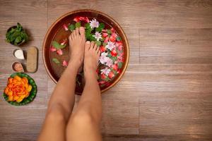 Top View  shot of a woman feet dipped in water photo