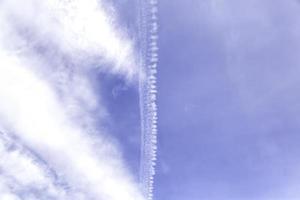 Clouds and airplane smoke photo