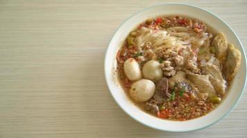 Noodles with pork and meatballs in spicy soup or Tom yum noodles video