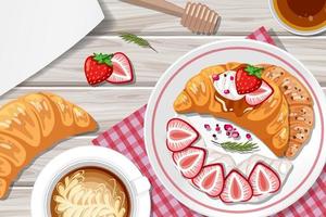 Croissant with strawberry and a cup of coffee on the table background vector