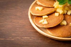 Apple pancakes or apple crepe with cinnamon powder photo