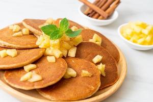 Apple pancakes or apple crepe with cinnamon powder photo