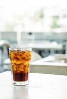 Iced cola glass on the table photo